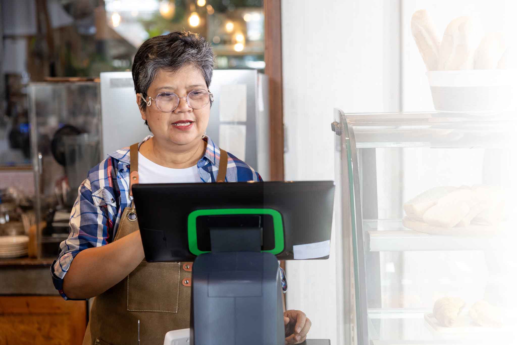 Business owner standing at checkout
